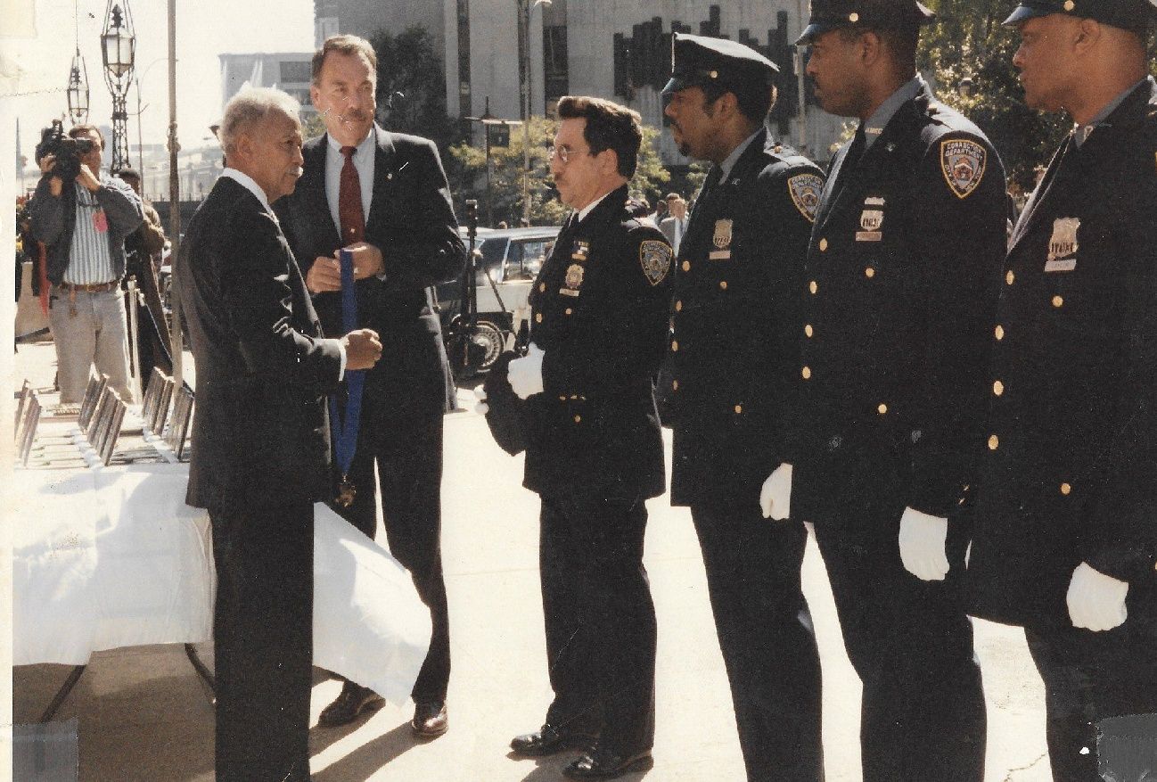 Correction Officer Neal L. Gossett receiving the Honorable Mention Medal from Mayor David Dinkins